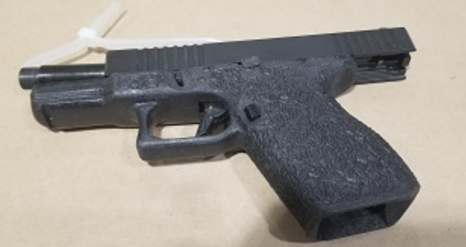 Gang enforcement team arrest 21 year old with loaded firearm and jerrycan